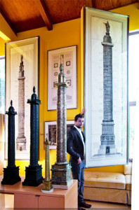 The Vendome Column was widely reproduced as the symbol of Napoleon's empire. Here three large bronze replicas of the Vendome Column are before two Piranesi prints of Rome's Trajan's and Antonine Columns.